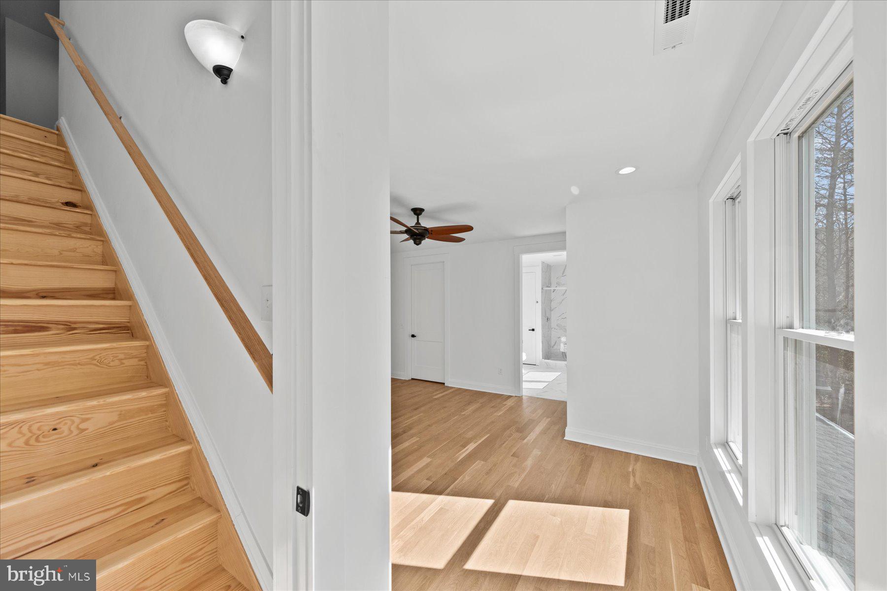 30425 Hollymount Road Harbeson, DE 19951 - Photo 61 of 98 a view of a hallway with wooden floor and staircase