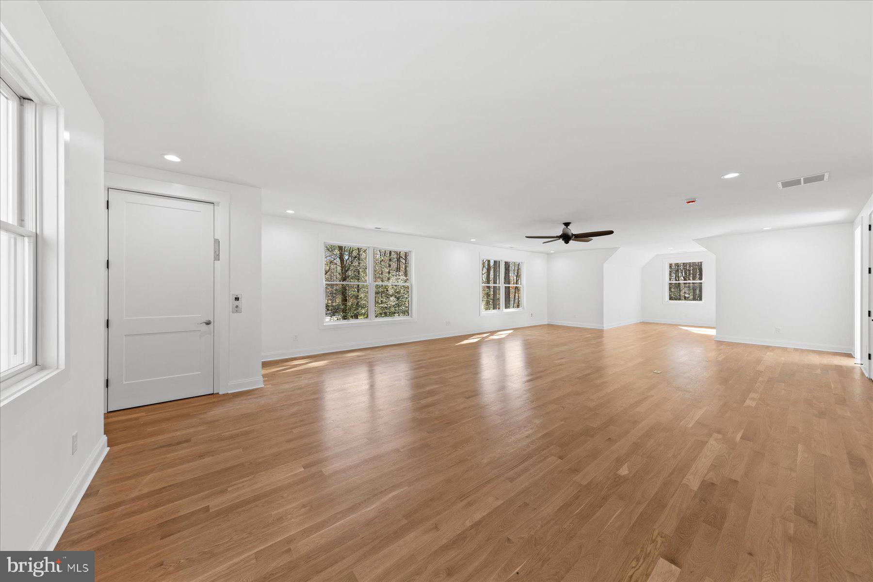 30425 Hollymount Road Harbeson, DE 19951 - Photo 69 of 98 an empty room with wooden floor and windows