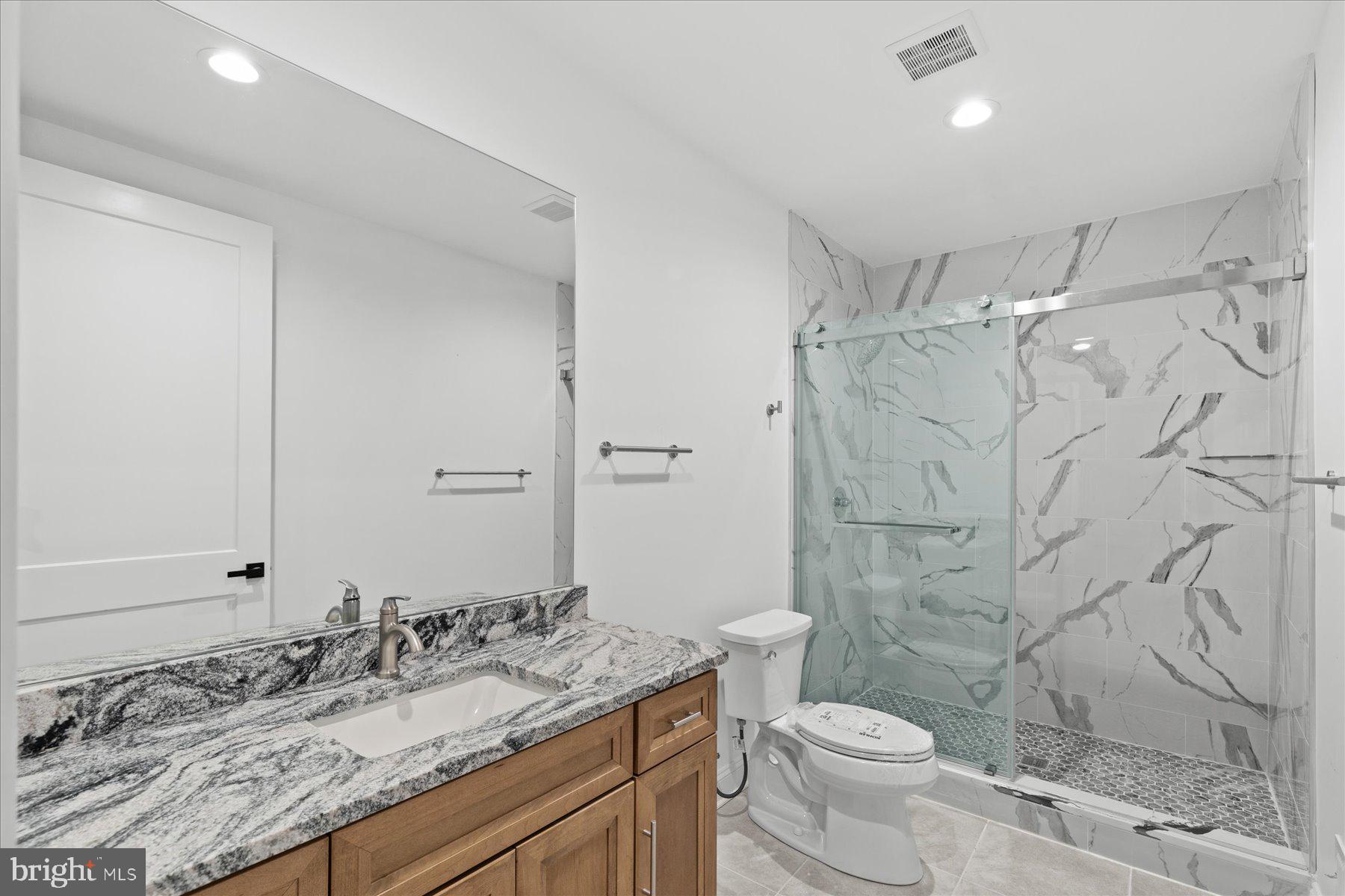 30425 Hollymount Road Harbeson, DE 19951 - Photo 75 of 98 a bathroom with a granite countertop sink toilet and shower