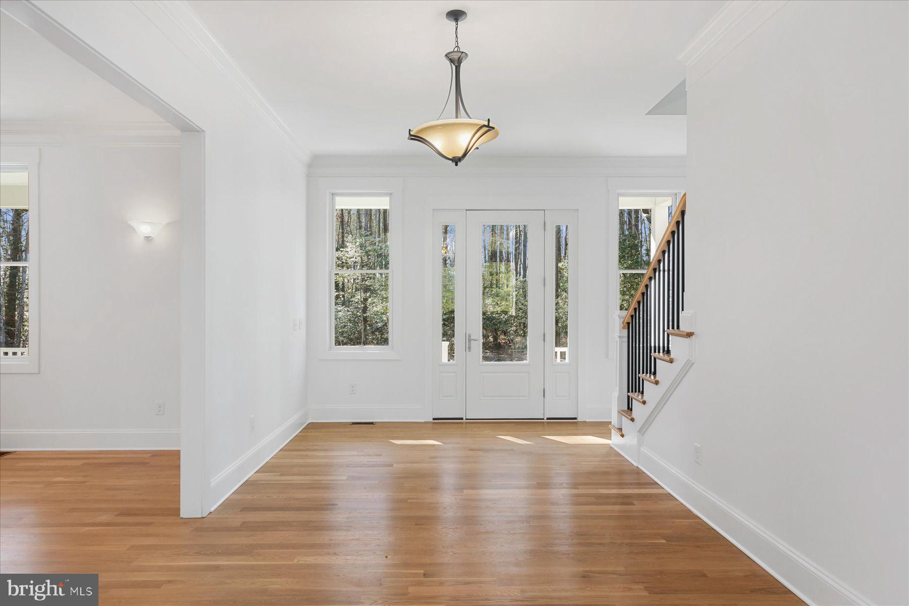 30425 Hollymount Road Harbeson, DE 19951 - Photo 10 of 98 a view of an empty room with a window and wooden floor