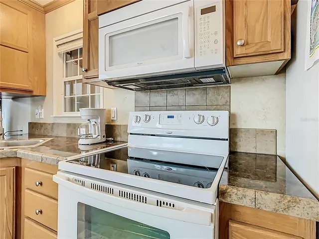 a kitchen with stainless steel appliances granite countertop a stove and cabinets