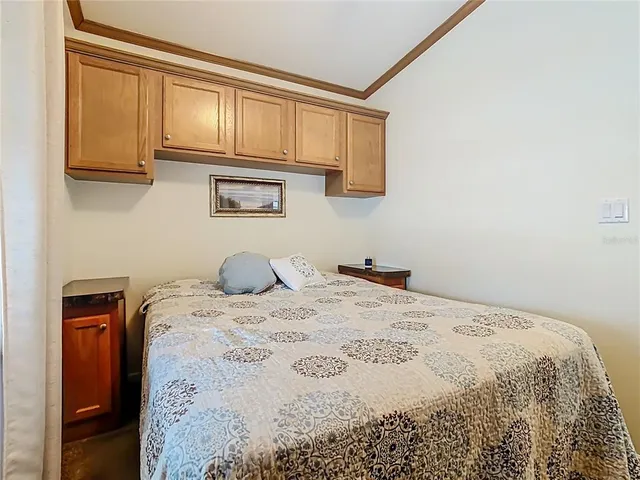 a bedroom with a bed and painting on the wall