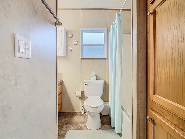a white toilet sitting next to a bathroom sink