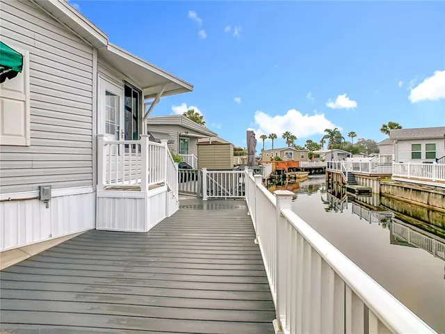 a view of a balcony with wooden floor and fence