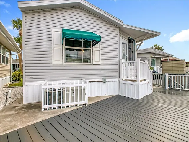 a view of a house with wooden deck