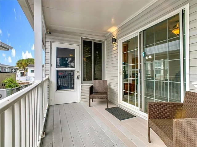 a balcony with furniture and wooden floor