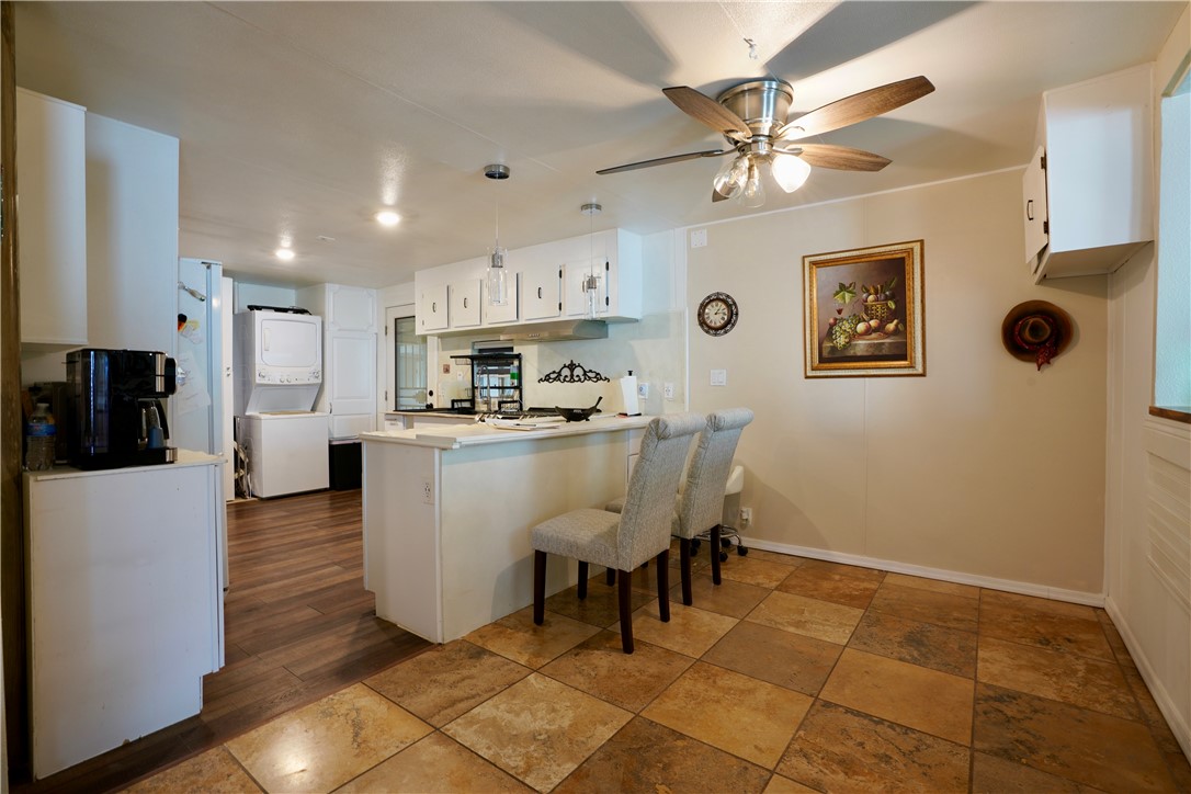 7296 Ligurta Road Golden Valley, AZ 86413 - Photo 16 of 49 a living room with stainless steel appliances kitchen island granite countertop furniture and a view of kitchen