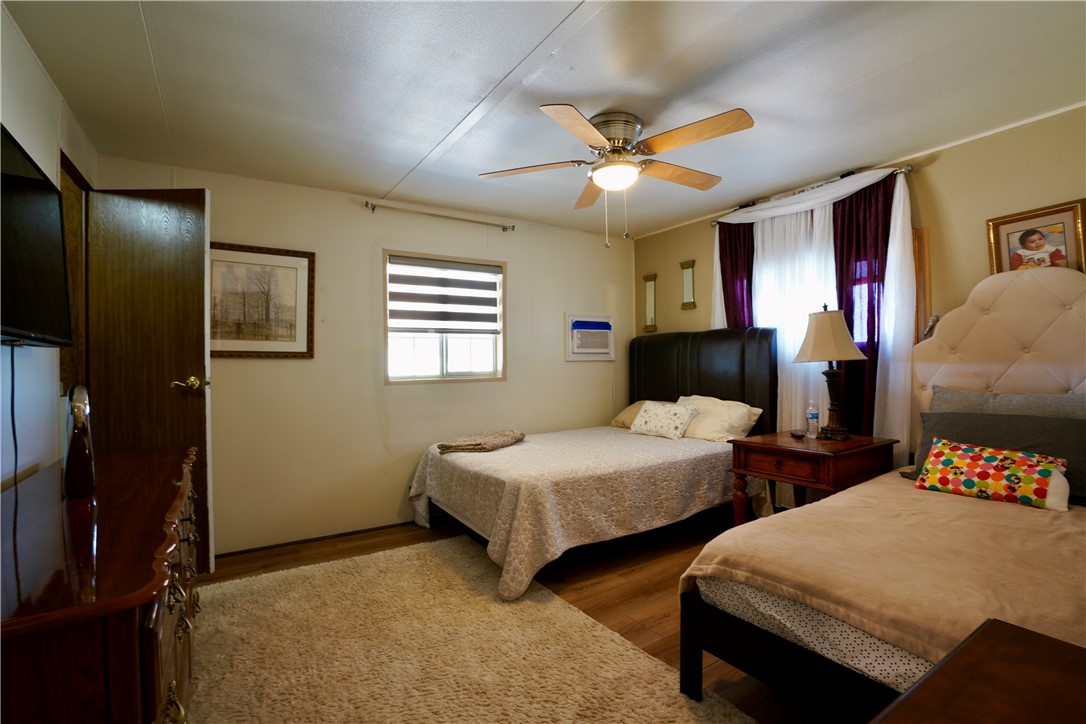 7296 Ligurta Road Golden Valley, AZ 86413 - Photo 26 of 49 a bedroom with two beds and a chandelier
