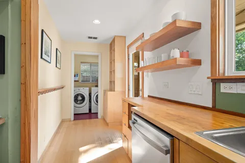 a living room with furniture a dining table and a flat screen tv