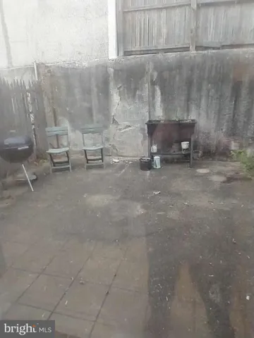 a living room with wooden floor and tv