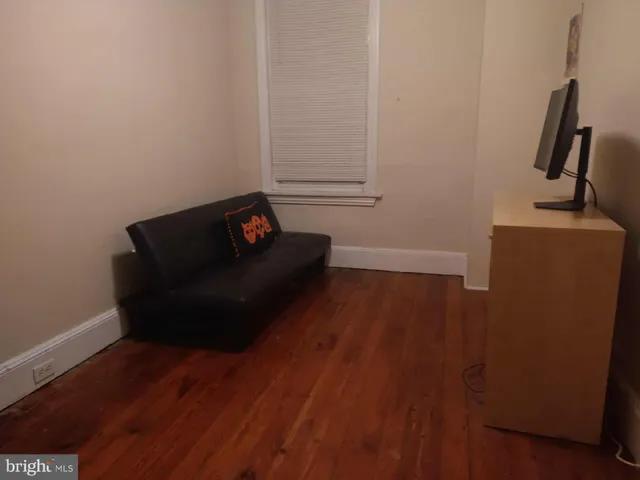 a bedroom with a bed and a desk