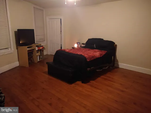 a bedroom with a bed and flat screen tv