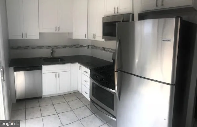 a kitchen with a sink and a refrigerator