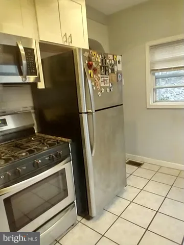 a white refrigerator freezer and a stove sitting inside of a kitchen