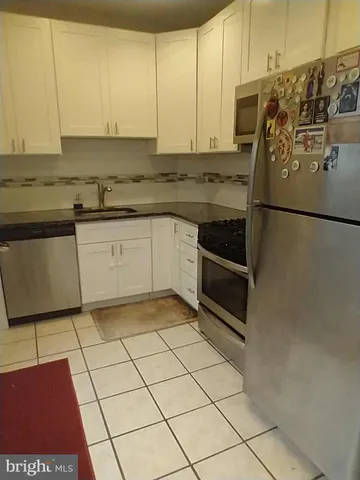 a kitchen with stainless steel appliances granite countertop a refrigerator sink and cabinets