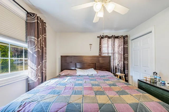 a bedroom with a bed and a chandelier