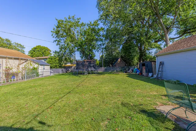 a view of a backyard with a table and chairs