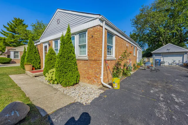a view of a house with a yard and pathway