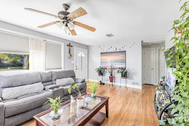 a living room with furniture and a wooden floor