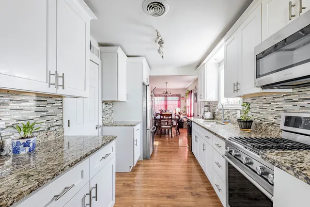 a kitchen with stainless steel appliances granite countertop a lot of counter space a sink and cabinets