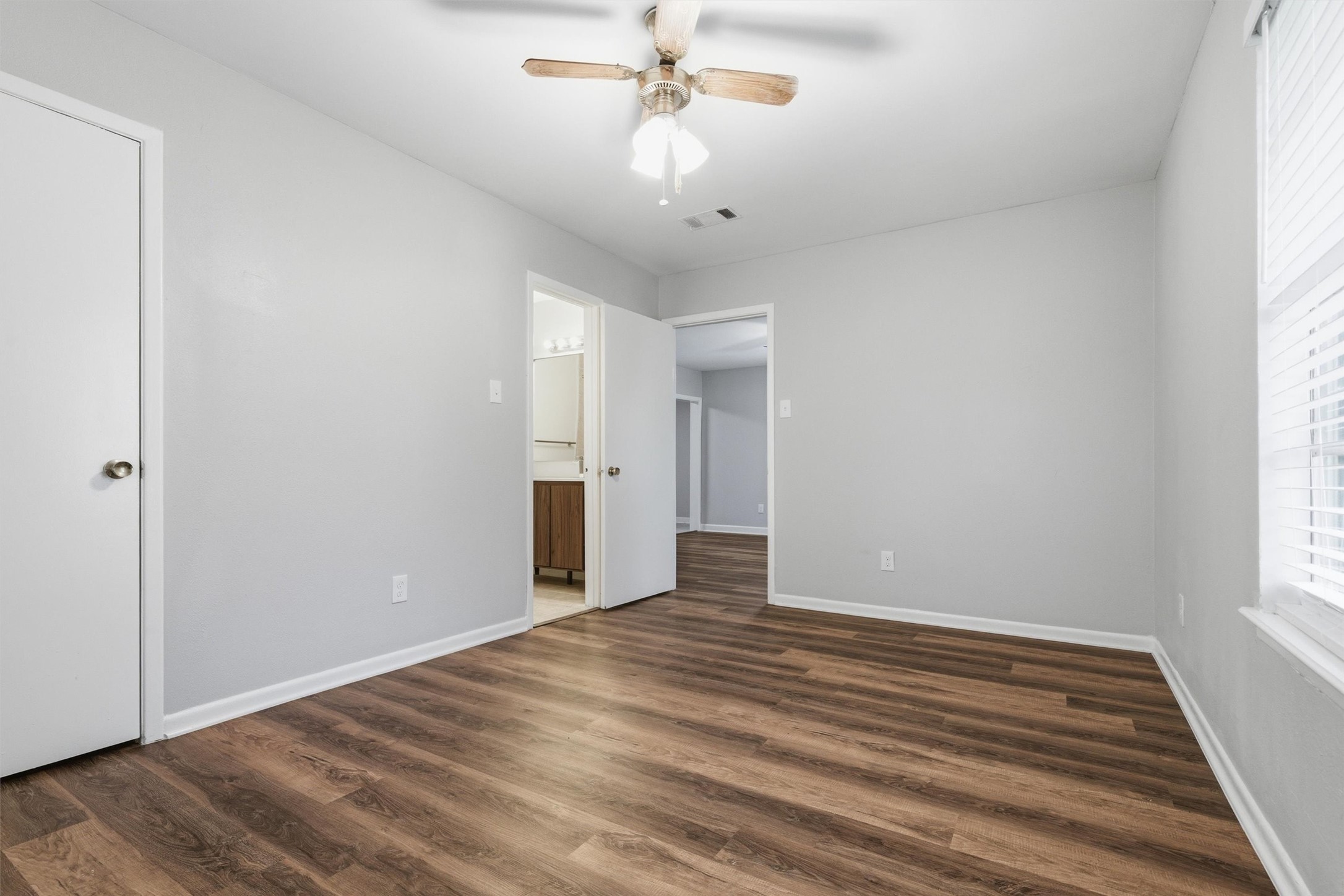 3615 Alberta Street Houston, TX 77021 - Photo 8 of 16 a view of an empty room with wooden floor and a window
