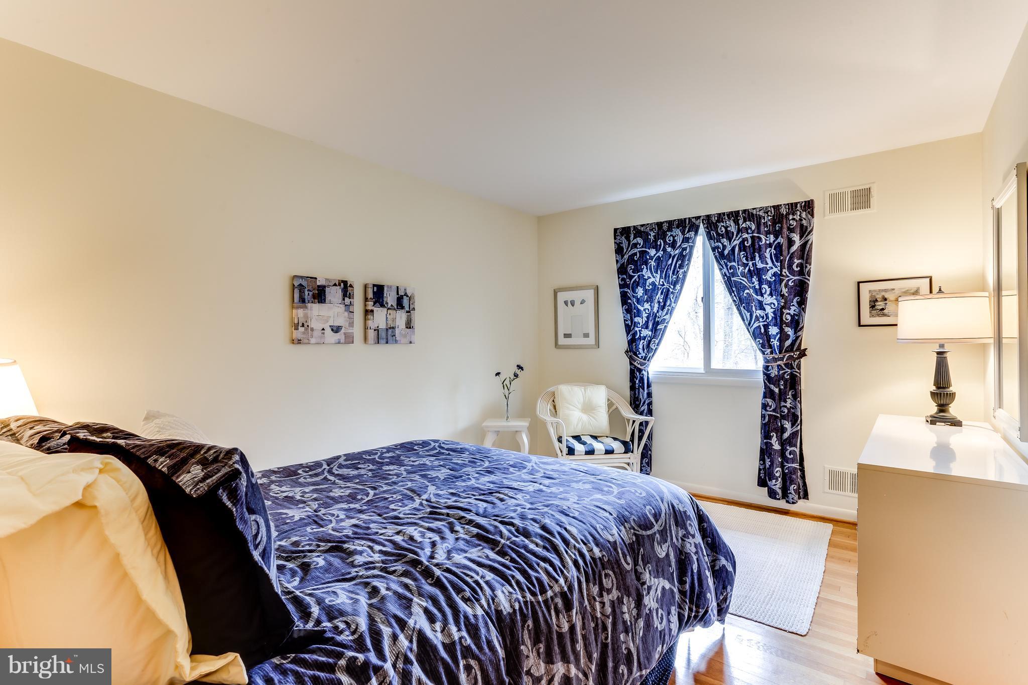 1713 Gamewell Road Silver Spring, MD 20905 - Photo 19 of 30 a bedroom with a bed and a chandelier