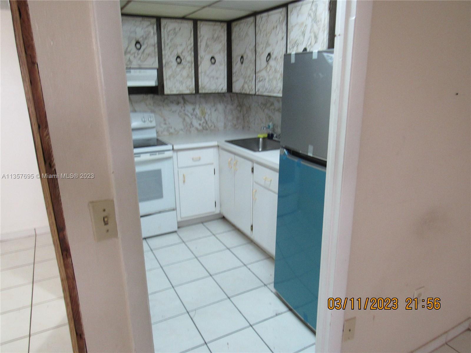 Flagami Miami, FL 33126 - Photo 5 of 12 a kitchen with a refrigerator and cabinets