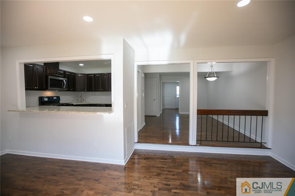 3405 Hana Road Edison, NJ 08817 - Photo 28 of 69 a view of a hallway with wooden floor and staircase
