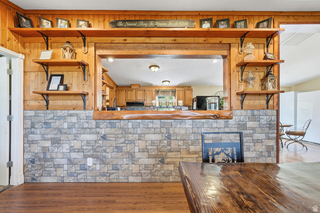 8066 North Valley View Heights Preston, ID 83263 - Photo 11 of 34 Open concept interior featuring a wood-finish floor and stone-look wainscoting