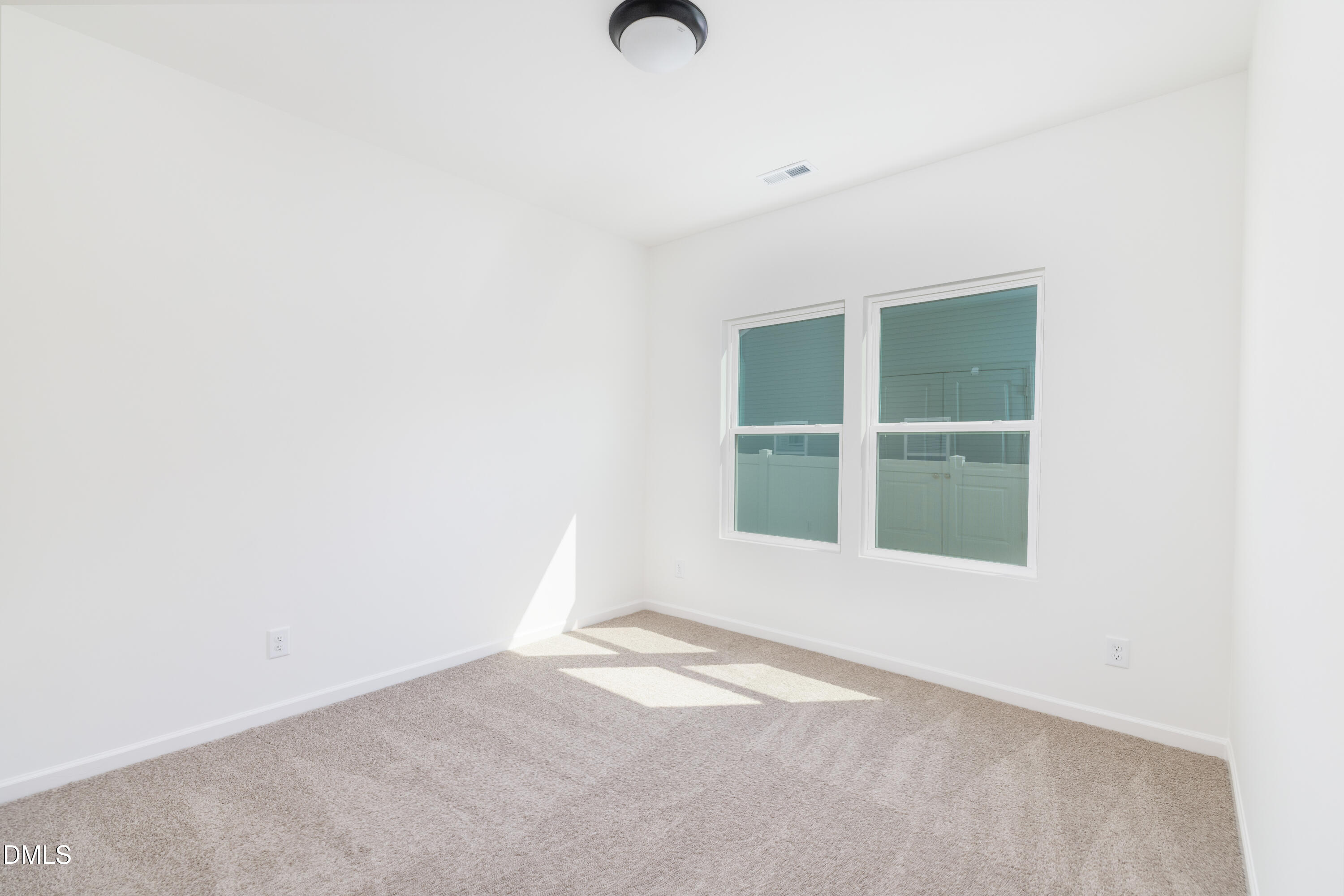 107 South Mule Way, Unit 90 Benson, NC 27504 - Photo 22 of 28 a view of an empty room with a window