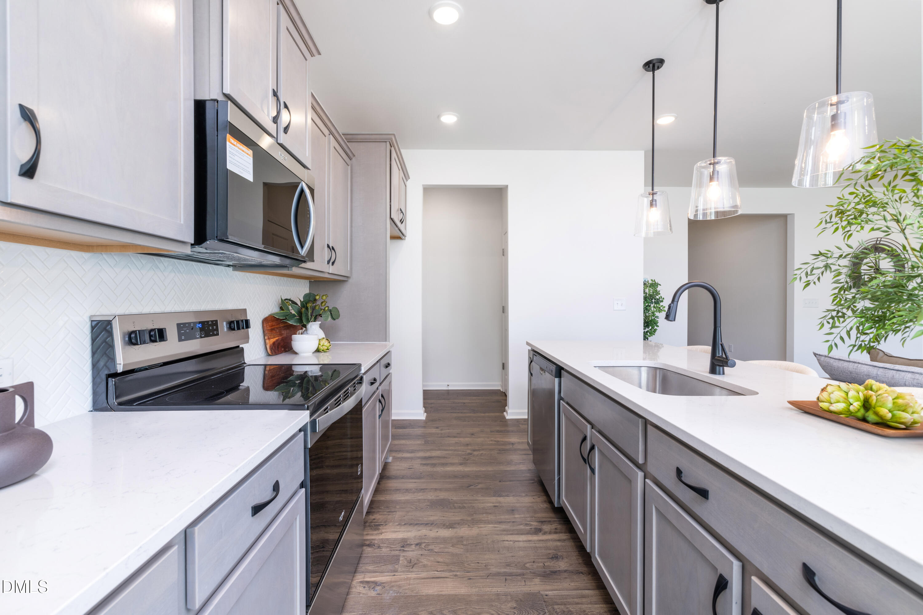 107 South Mule Way, Unit 90 Benson, NC 27504 - Photo 5 of 28 a kitchen with stainless steel appliances a sink stove and cabinets