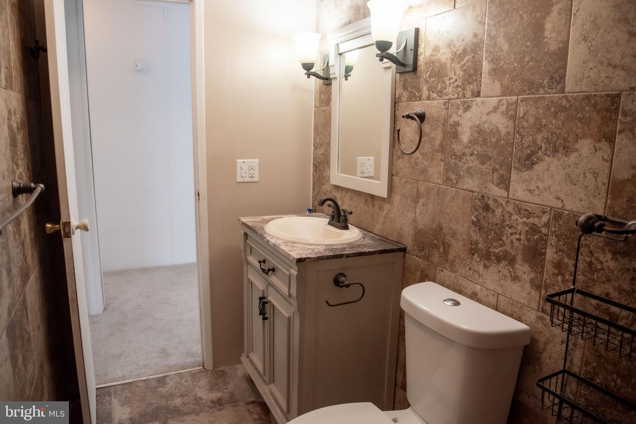 8705 Alsop Town Road Spotsylvania, VA 22551 - Photo 11 of 15 a bathroom with a sink toilet and shower