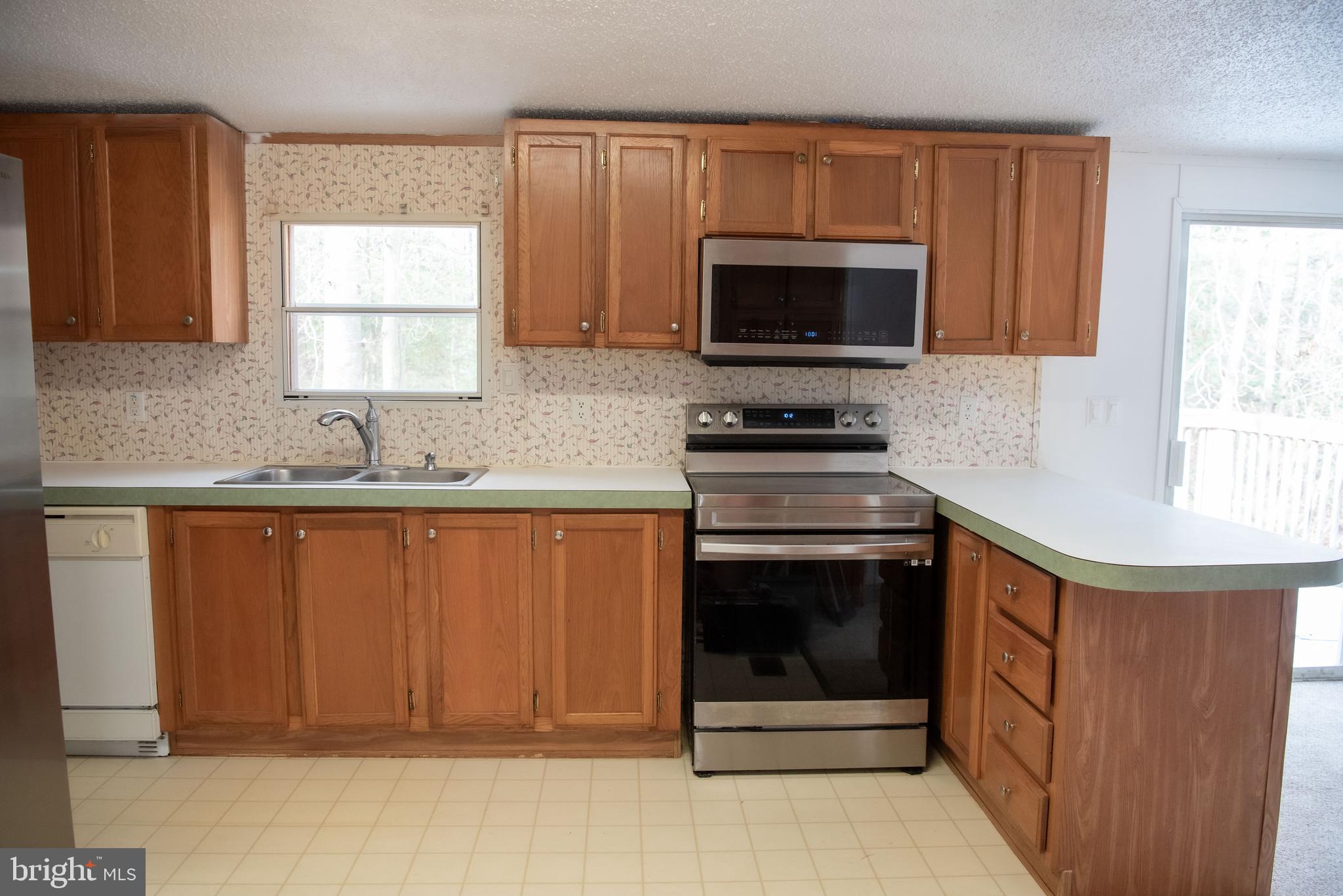 8705 Alsop Town Road Spotsylvania, VA 22551 - Photo 12 of 15 a kitchen with granite countertop a sink stove and microwave