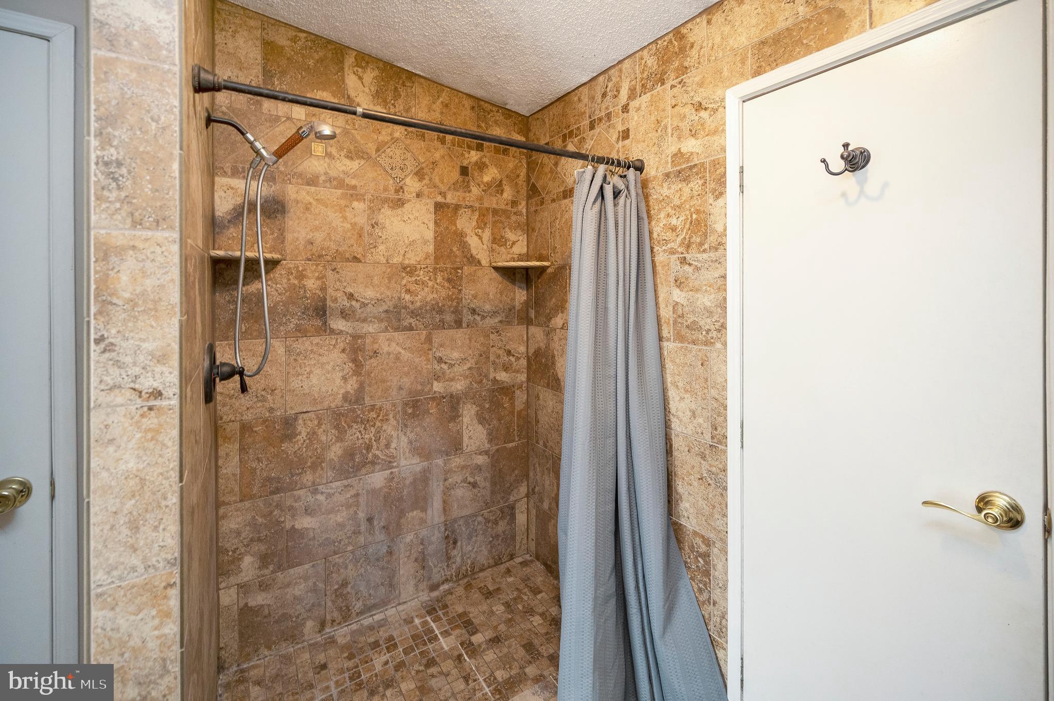 8705 Alsop Town Road Spotsylvania, VA 22551 - Photo 12 of 33 a bathroom with a shower and a glass door