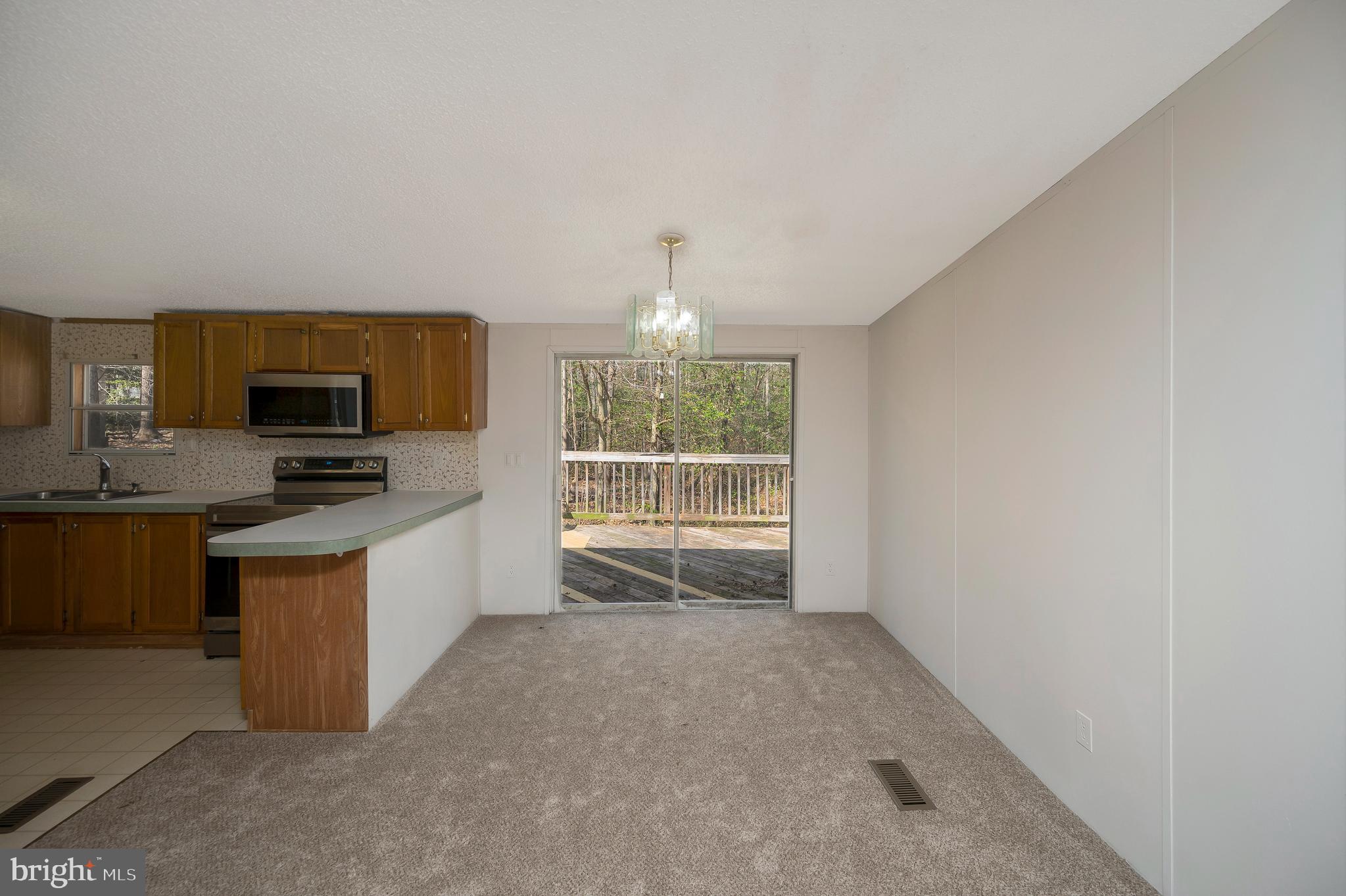 8705 Alsop Town Road Spotsylvania, VA 22551 - Photo 13 of 33 a kitchen with stainless steel appliances a stove top oven a sink a counter top space and cabinets
