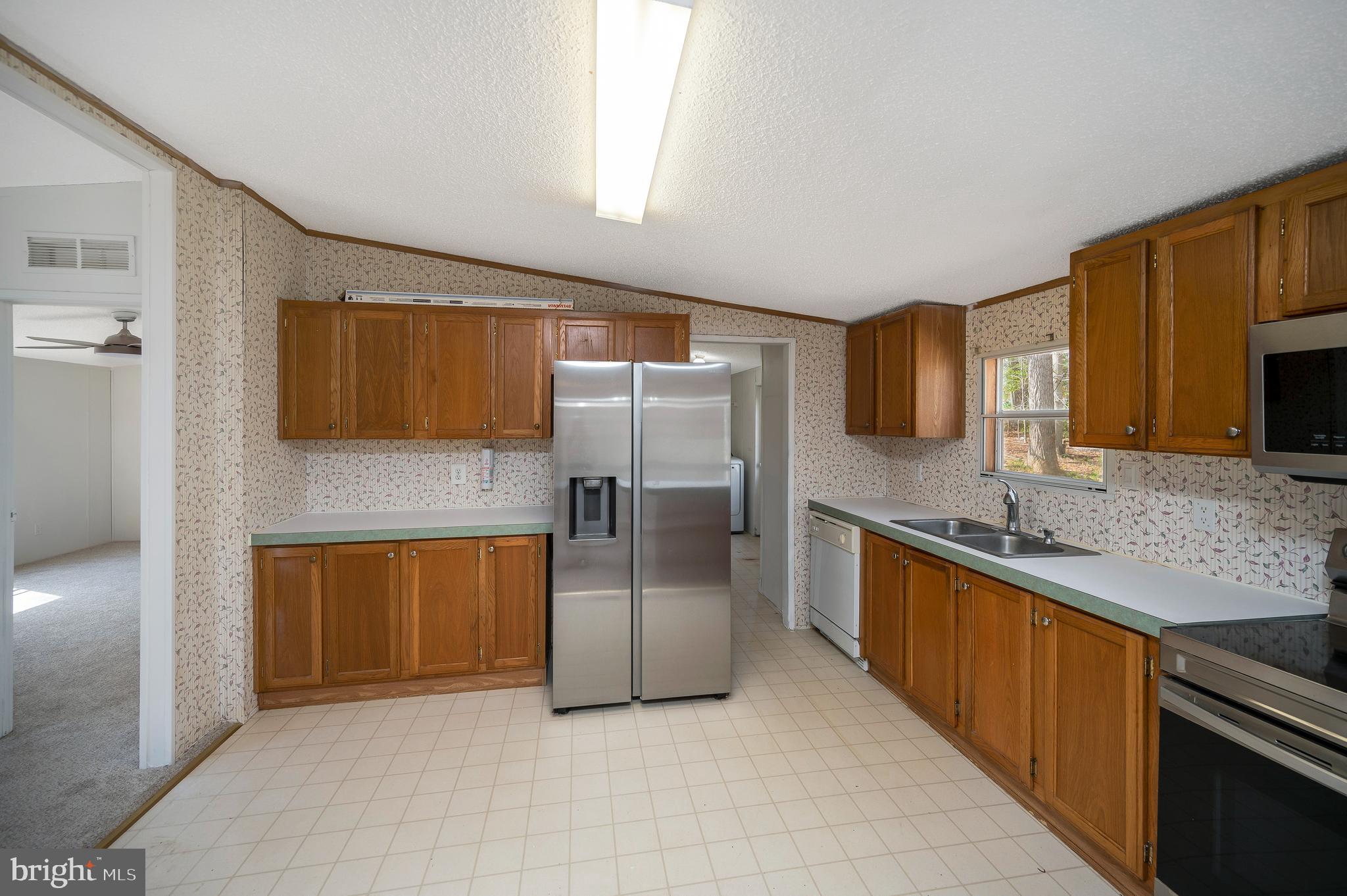 8705 Alsop Town Road Spotsylvania, VA 22551 - Photo 16 of 33 a kitchen with stainless steel appliances granite countertop a refrigerator and a sink