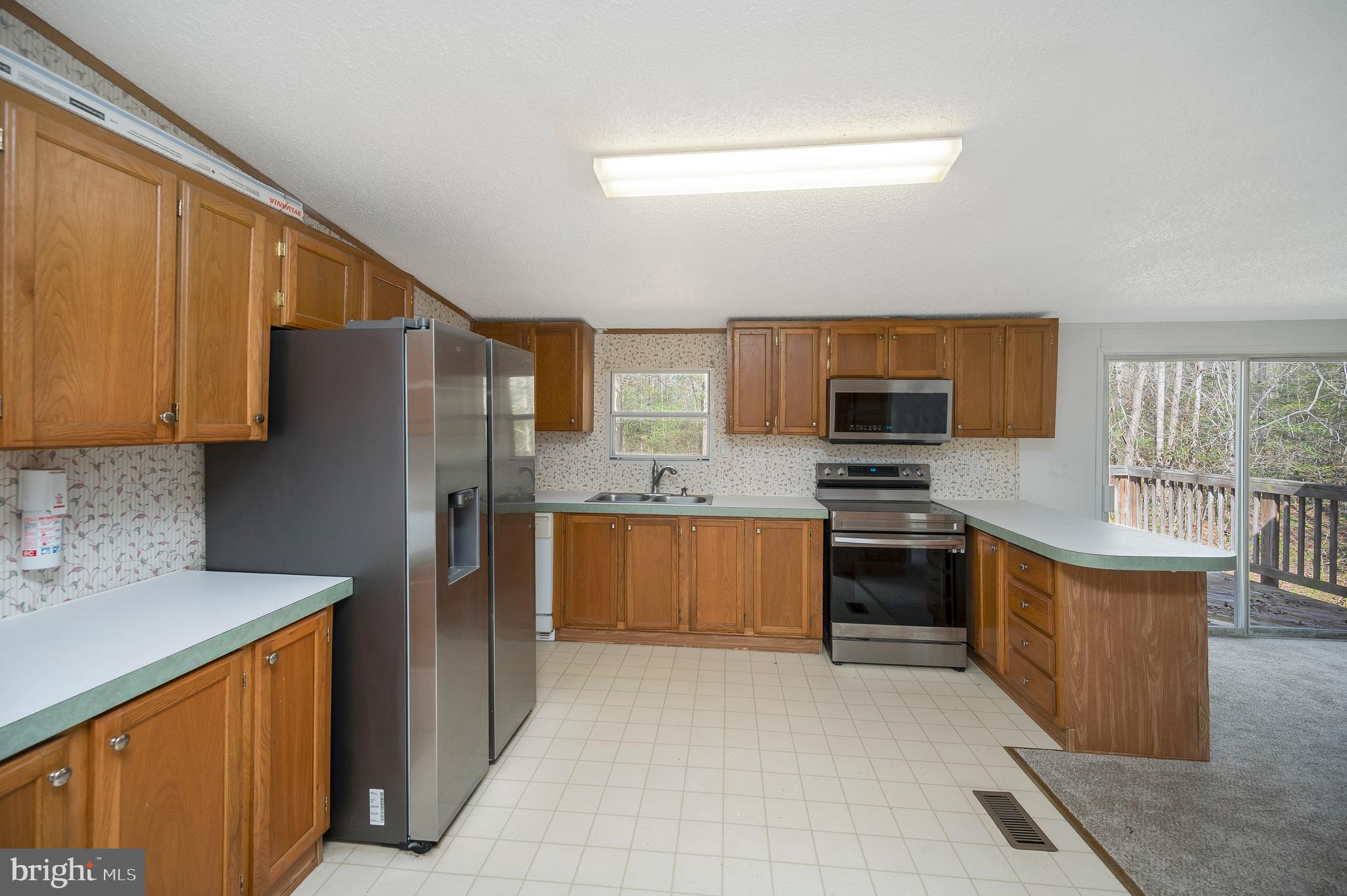 8705 Alsop Town Road Spotsylvania, VA 22551 - Photo 17 of 33 a kitchen with stainless steel appliances granite countertop a refrigerator stove and sink