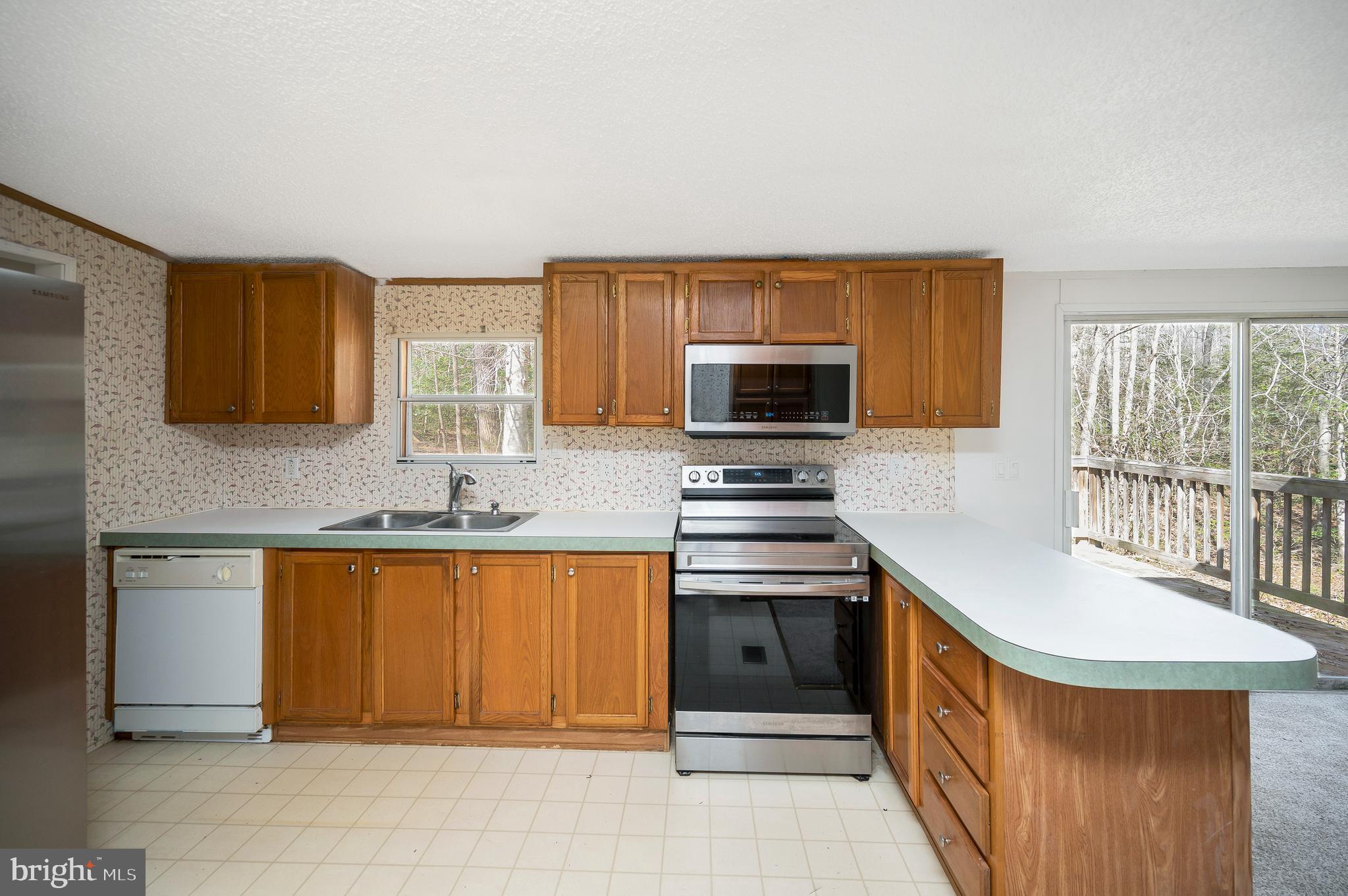 8705 Alsop Town Road Spotsylvania, VA 22551 - Photo 18 of 33 a kitchen with stainless steel appliances a stove a sink and a microwave