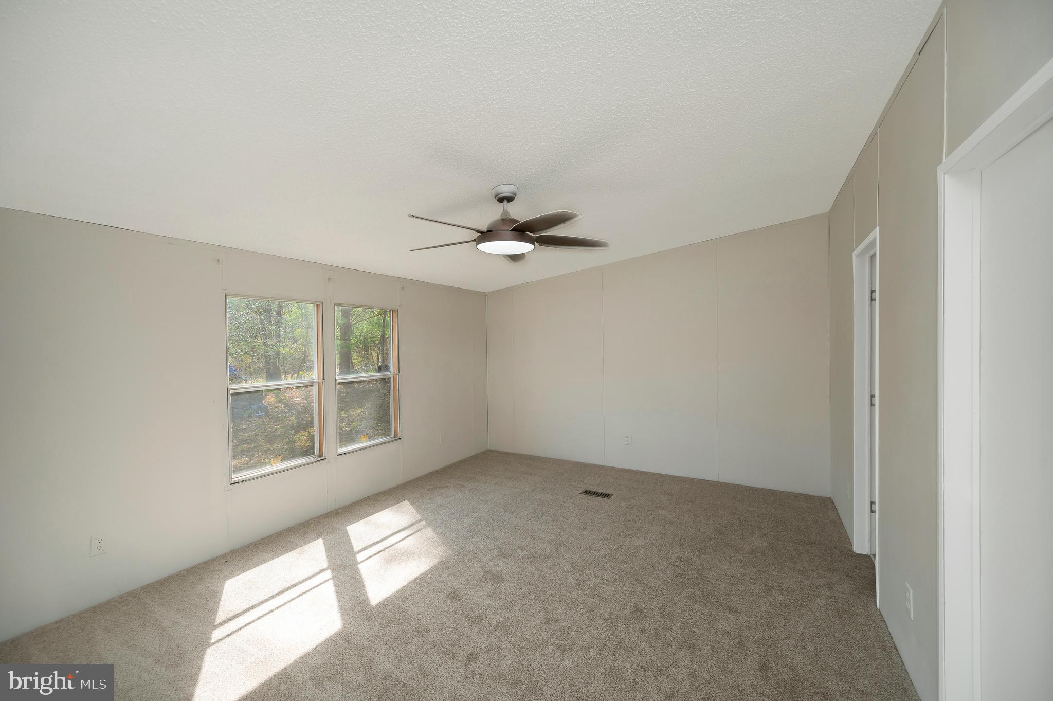 8705 Alsop Town Road Spotsylvania, VA 22551 - Photo 23 of 33 an empty room with a window and ceiling fan