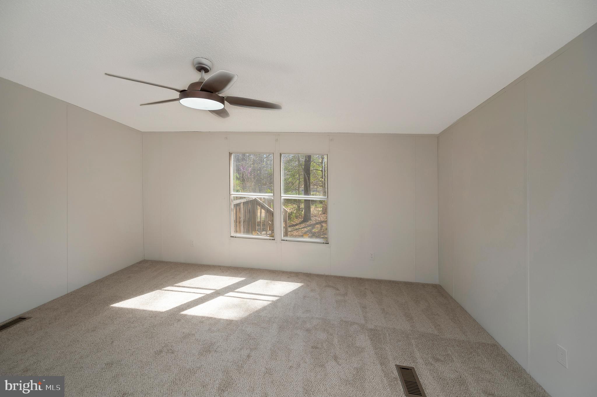 8705 Alsop Town Road Spotsylvania, VA 22551 - Photo 24 of 33 an empty room with windows and fan