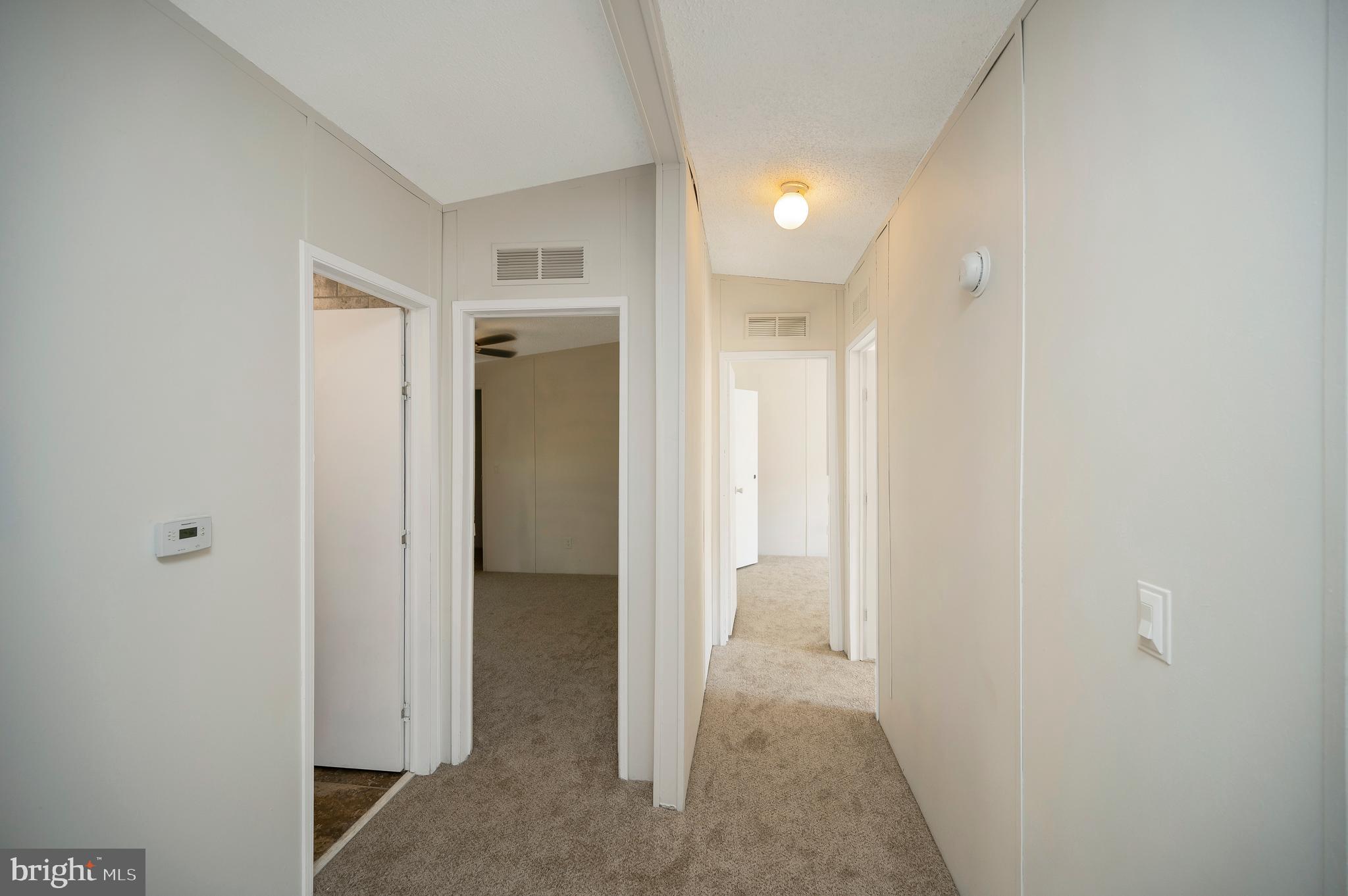 8705 Alsop Town Road Spotsylvania, VA 22551 - Photo 27 of 33 a view of a hallway with wooden shelves