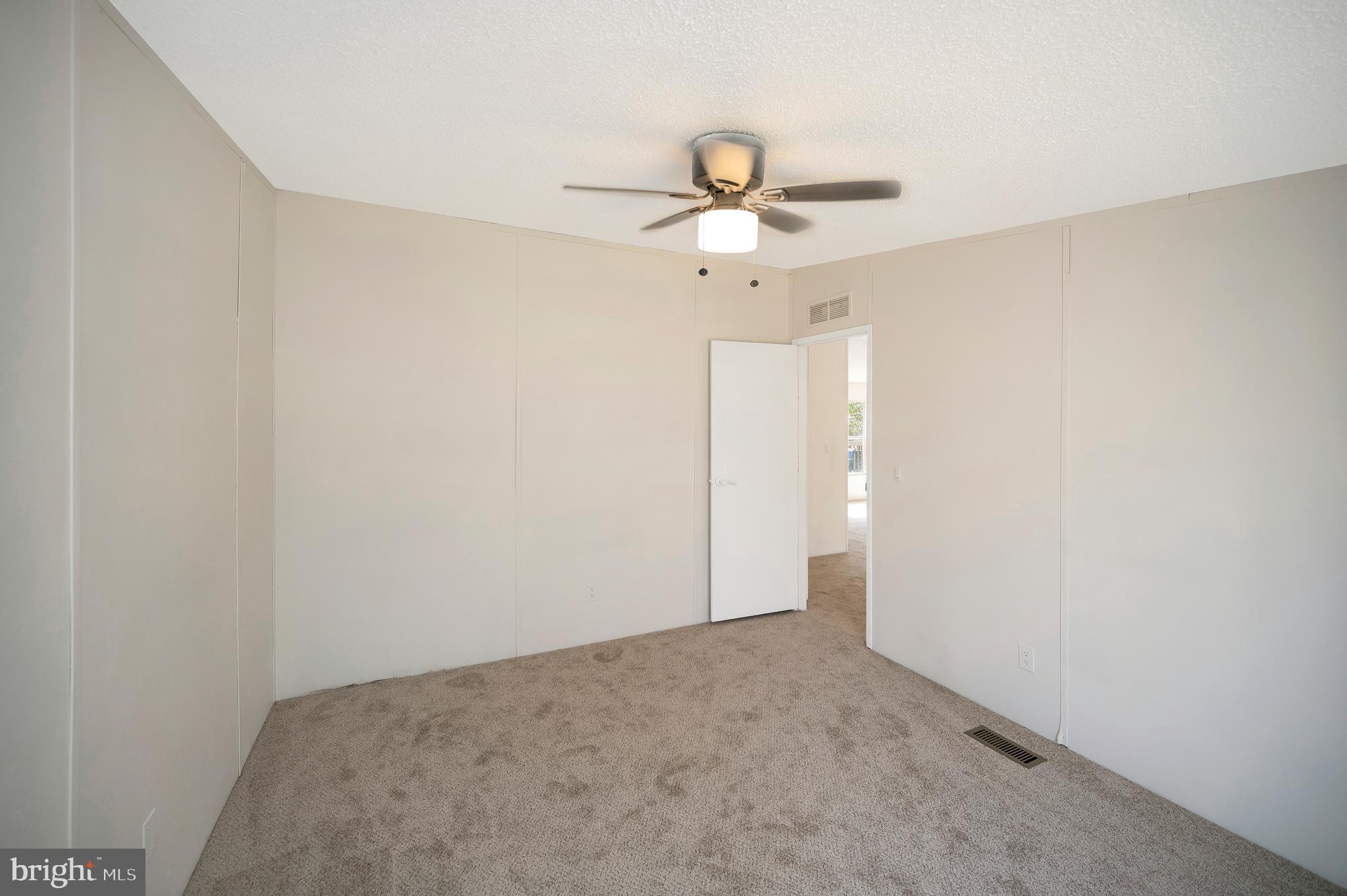 8705 Alsop Town Road Spotsylvania, VA 22551 - Photo 29 of 33 an empty room with a ceiling fan and a window