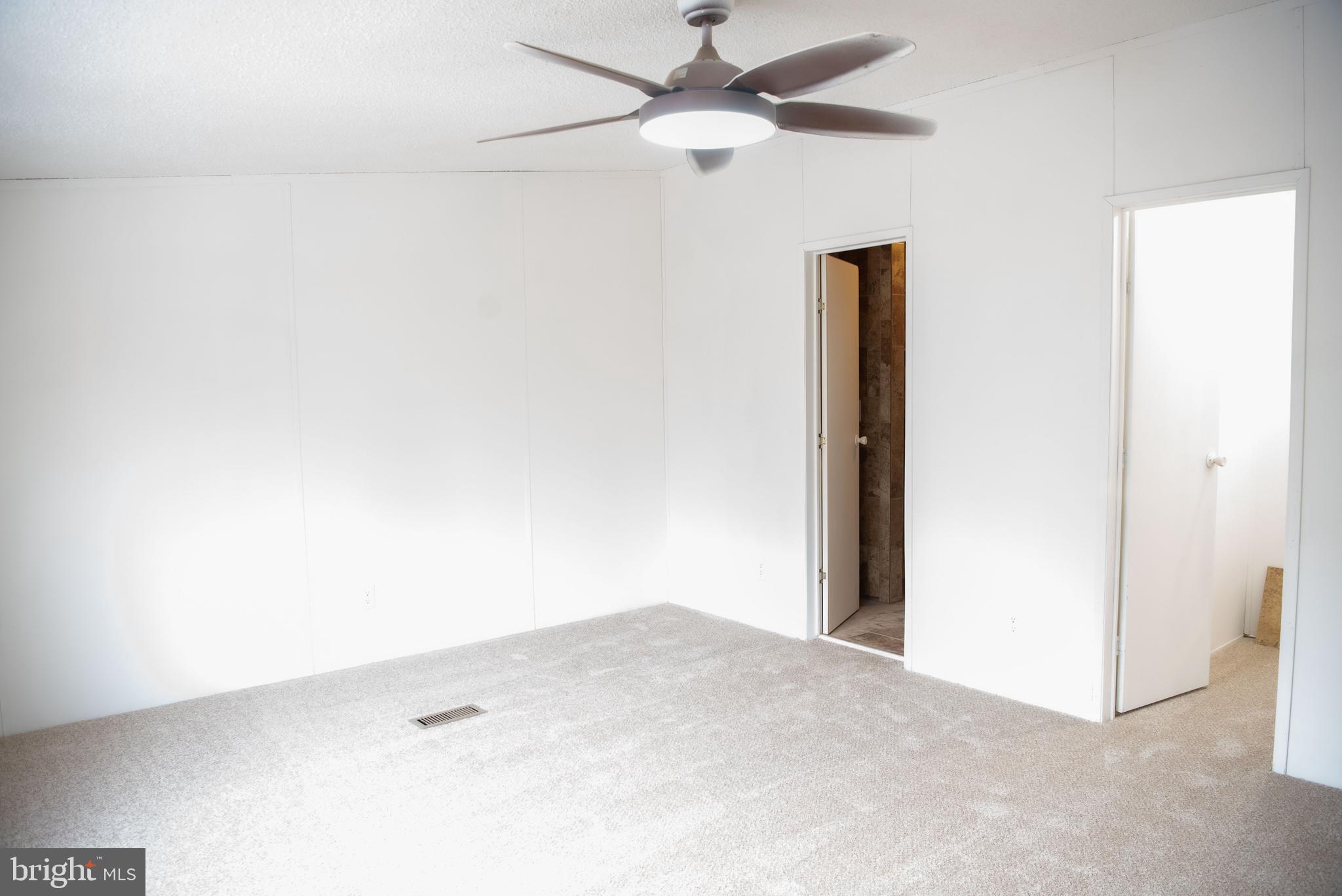 8705 Alsop Town Road Spotsylvania, VA 22551 - Photo 4 of 15 an empty room with a ceiling fan and a window