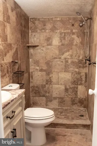 a bathroom with a toilet and a shower