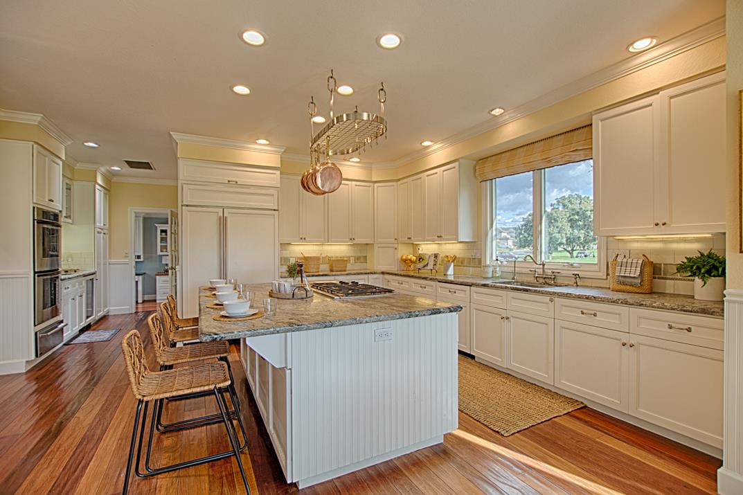 2140 Winged Foot Road Half Moon Bay, CA 94019 - Photo 11 of 52 a kitchen with kitchen island a large counter top space a sink stainless steel appliances and cabinets