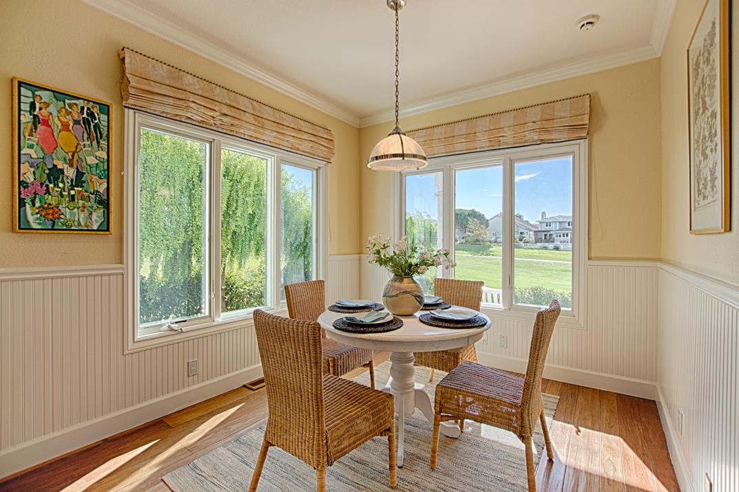 2140 Winged Foot Road Half Moon Bay, CA 94019 - Photo 13 of 52 a dining room with furniture large windows and wooden floor