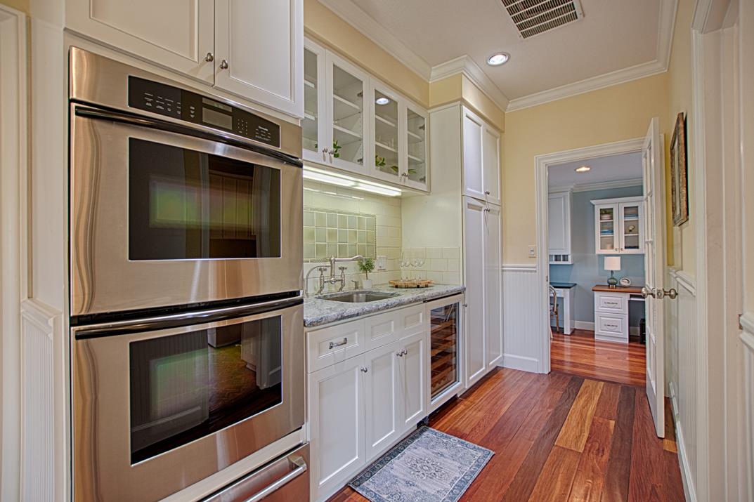 2140 Winged Foot Road Half Moon Bay, CA 94019 - Photo 14 of 52 a kitchen with granite countertop cabinets stainless steel appliances and wooden floor