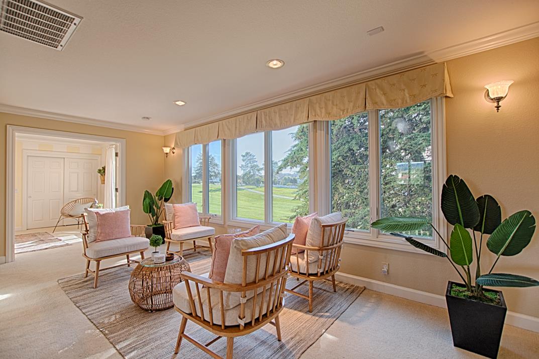 2140 Winged Foot Road Half Moon Bay, CA 94019 - Photo 24 of 52 a living room with furniture a potted plant and a large window