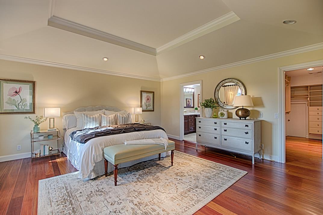 2140 Winged Foot Road Half Moon Bay, CA 94019 - Photo 32 of 52 a bedroom with a bed and wooden floor