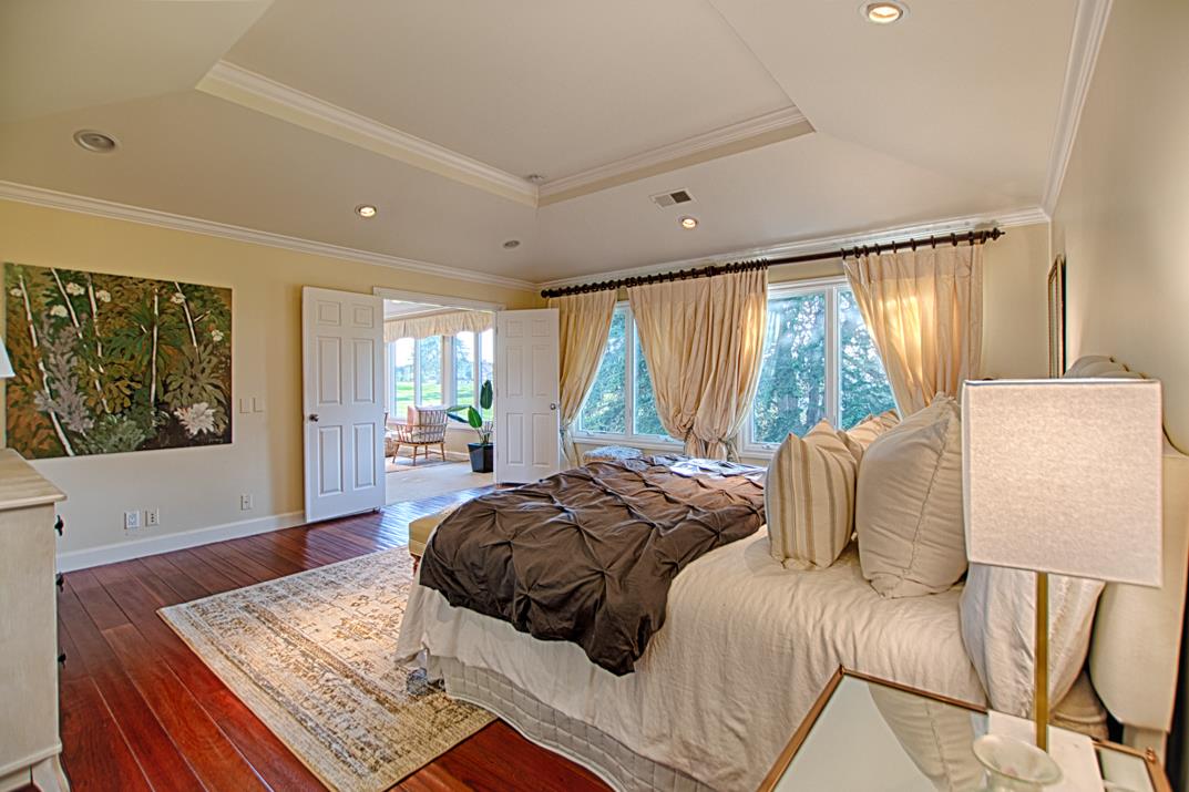 2140 Winged Foot Road Half Moon Bay, CA 94019 - Photo 34 of 52 a bedroom with a bed and glass window